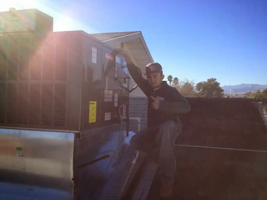 HVAC technician performing HVAC Inspection on a rooftop unit in Park Ridge