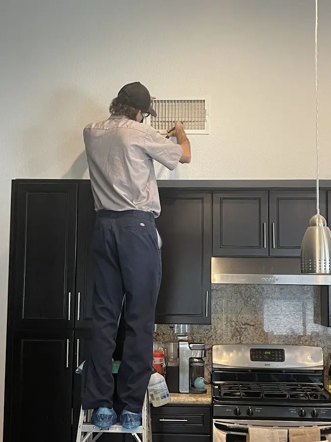 Technician inspecting an air vent during HVAC service in Park Ridge